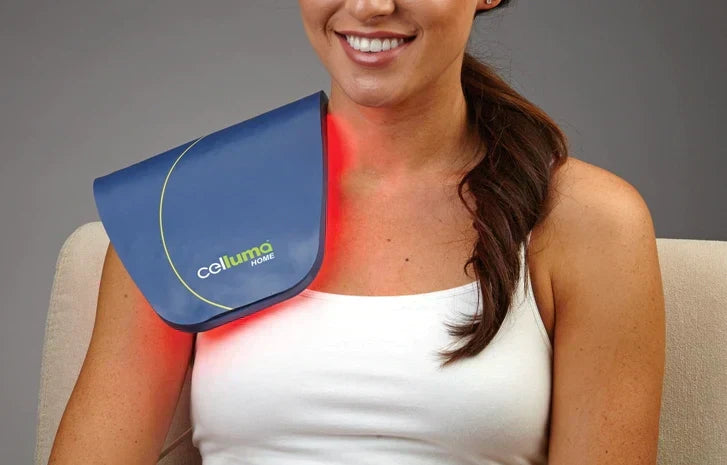 A woman using a Celluma red light therapy device at home