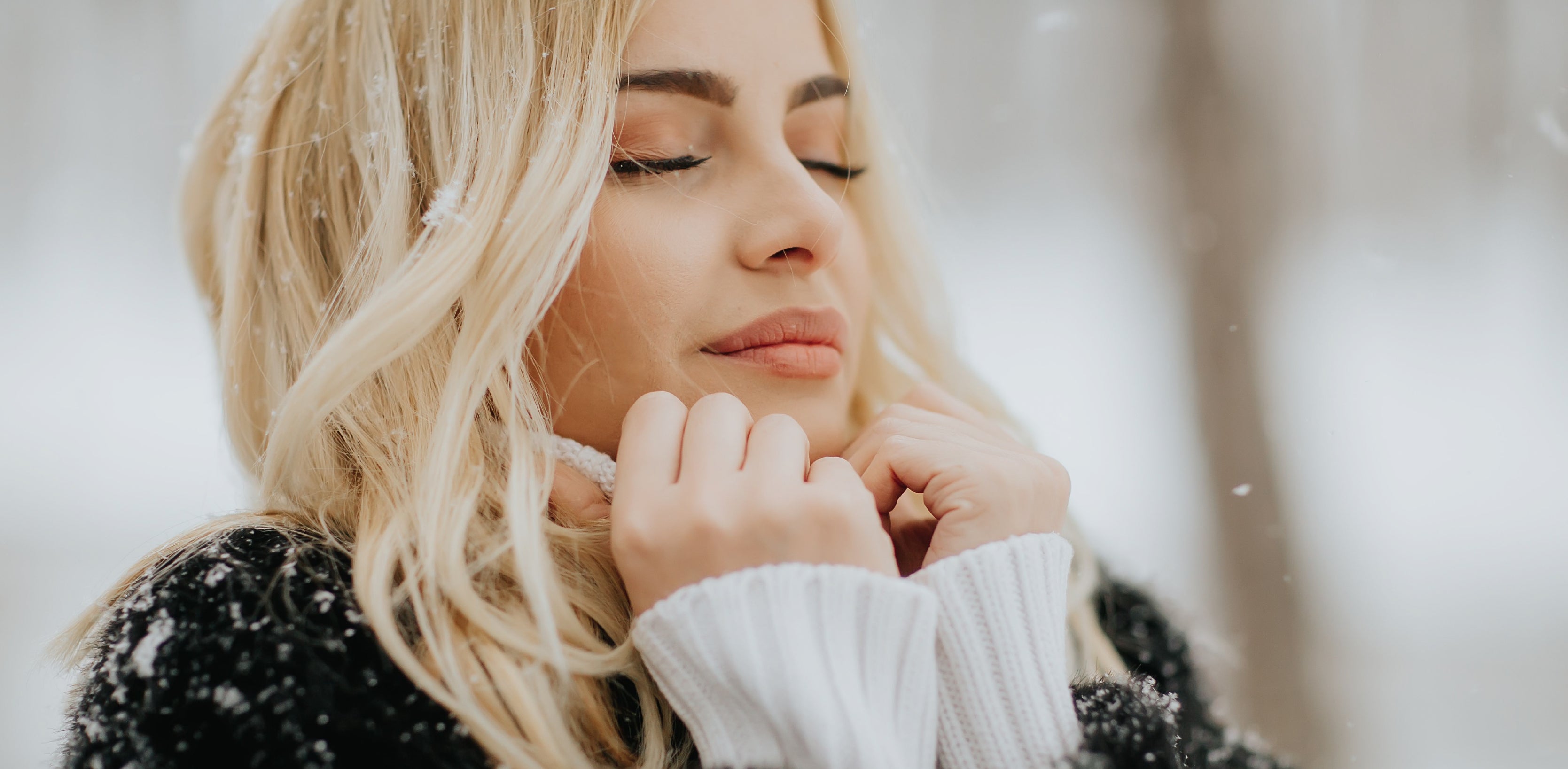 Woman outdoors in winter protecting dry skin with healthy skincare routine inspired by Celluma Light Therapy