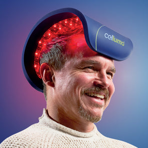 Man wearing the Celluma RESTORE LED light therapy device on top of the head to promote hair growth and restoration.